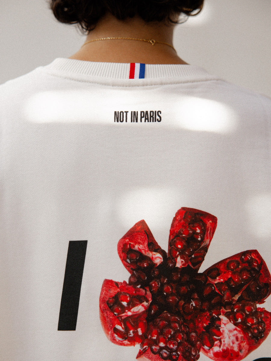 NOT IN PARIS I Nar Paris unisex tee — back print with a split pomegranate in place of the heart, off-white heavyweight cotton